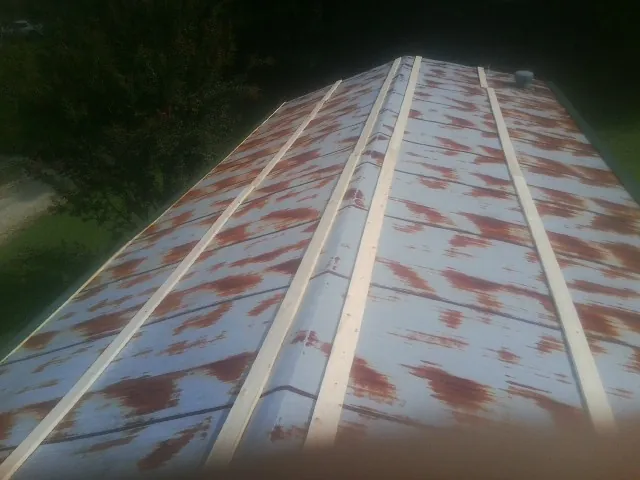 Rusted metal roof panels with new wood purlins before replacement — Storm Damage Roof Repair in Sutter Creek by Roofing Brothers